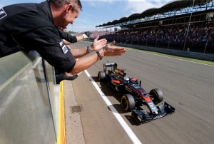 Team members celebrate Fernando Alonso's 5th place finish.