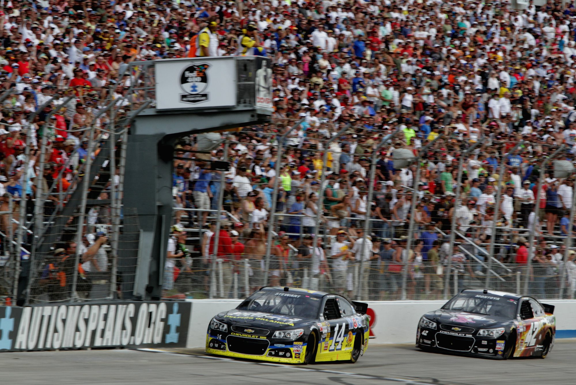 Tony-Stewart-checkered-flag-finish-NASCAR-Fed-Ex-Autism-Speaks-400