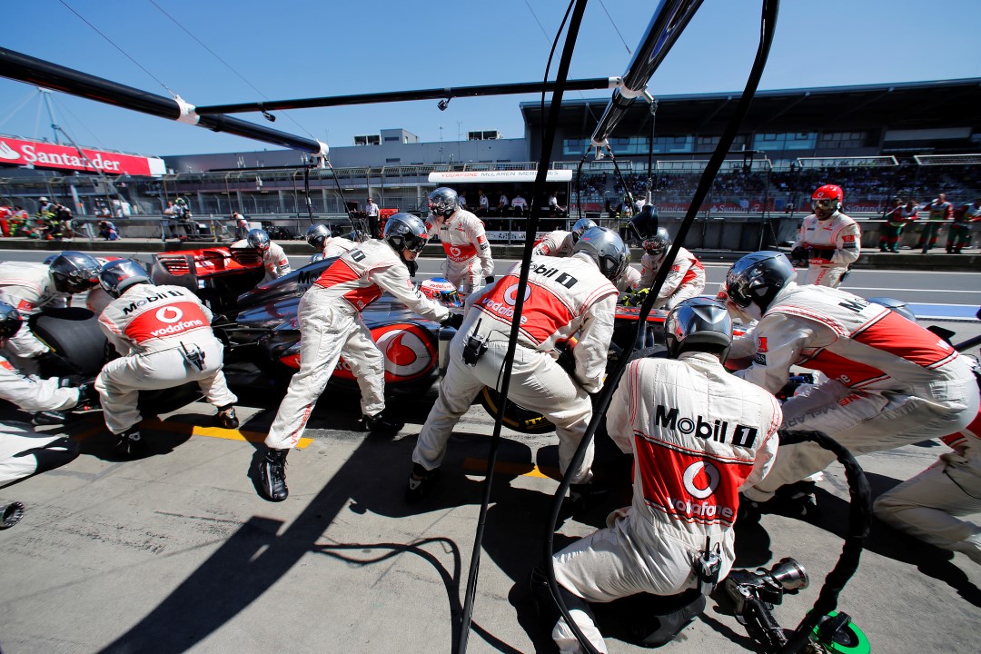 McLaren mechanics conduct a pit stop for Jenson button