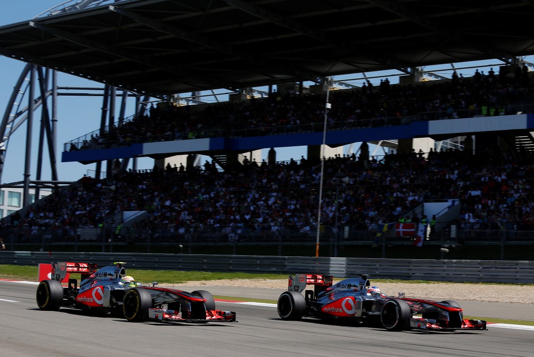 Jenson Button and Sergio Perez on track
