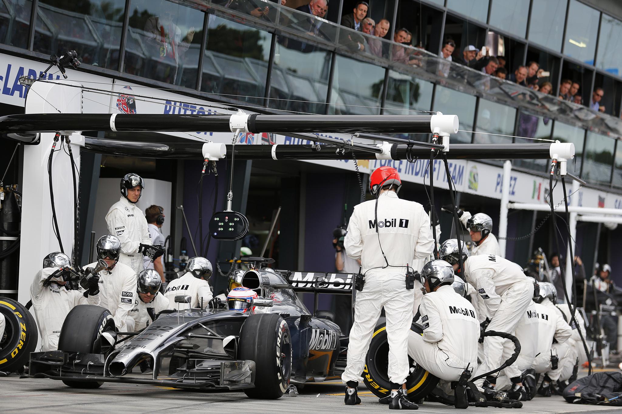 Jenson Button leaves the pits after making a stop.