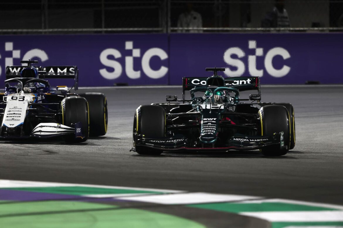 Lance Stroll, Aston Martin AMR21, leads George Russell, Williams FW43B