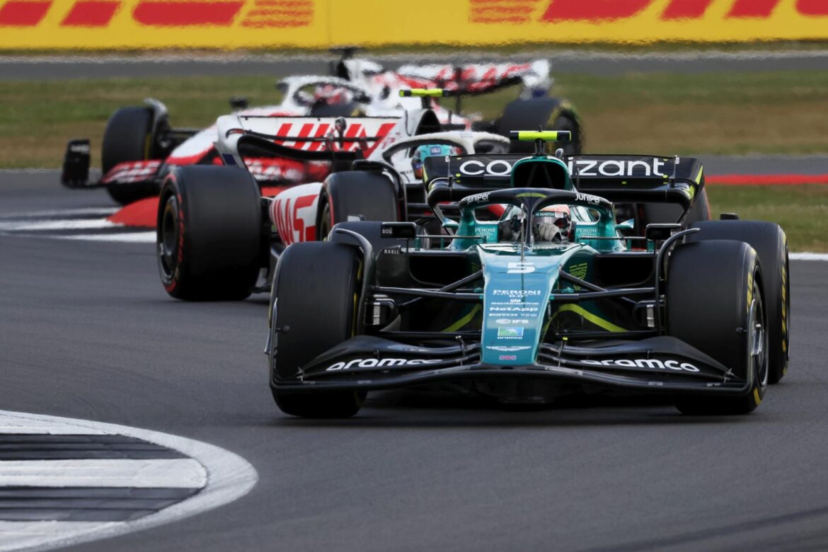 Sebastian Vettel, Aston Martin AMR22, leads Mick Schumacher, Haas VF-22