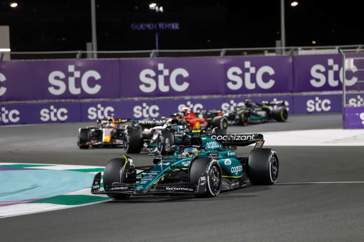 Fernando Alonso, Aston Martin AMR23, leads George Russell, Mercedes F1 W14